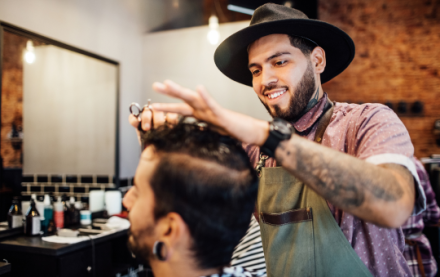 Young male barber cutting a client's hair