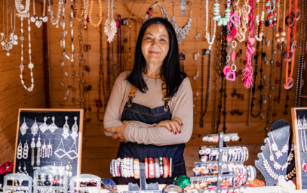 Woman standing in her market stall, selling jewelry